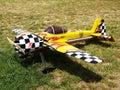 Model of radio controlled aircraft with a propeller yellow with black squares on the wings