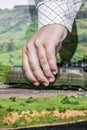 Model railroad. Hand placing locomotive.