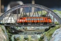 Model railroad. Portuguese locomotive on a bridge. Royalty Free Stock Photo