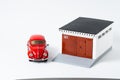 Model red car and small garage. Dream concept Royalty Free Stock Photo