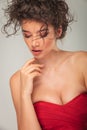 Model in red dress pose touching her chin Royalty Free Stock Photo