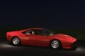 Model of a red Ferrari GTO car seen from the side lit by streetlights on the asphalt Royalty Free Stock Photo