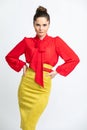 Model in red shirt, yellow suede skirt with red belt,  on white background. Royalty Free Stock Photo