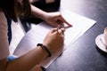 Model release document signing by woman hands on cafe table in morning Royalty Free Stock Photo