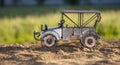 Model of a retro car on a sand mountain against a background of green grass Royalty Free Stock Photo