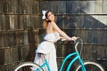 Model in romantic shape with vintage bicycle posing near wall Royalty Free Stock Photo