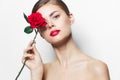 Model Rose in hand red lips charm clean skin long hair Royalty Free Stock Photo