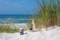 Model of a sailboat and a pile of stones in the sand dunes.