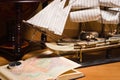 Model sailing ship, map book and compass Royalty Free Stock Photo