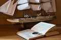 Model sailing ship, map book and compass Royalty Free Stock Photo