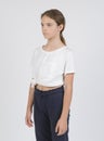 Model samples , waist high portrait ,1 white girl 11 years old in dark pants and a white shirt on a white