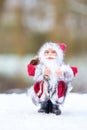 Model of Santa Claus standing in white snow outdoors Royalty Free Stock Photo