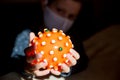 Red bright spiny ball  on dark background. Toy, close-up. Coronavirus model.model of the SARS-CoV-2 virus ,toy Royalty Free Stock Photo