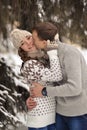 Man kiss her woman.Boy kiss her girl on cheek in the winter forest.True love. Royalty Free Stock Photo