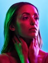Model skincare, glowing or neon lighting on isolated blue background and hands on neck, body or skin. Beauty, thinking