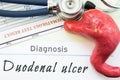 Model of stomach, blood test and stethoscope lying next to written title on paper diagnosis Duodenal Ulcer. Concept photo of cause Royalty Free Stock Photo