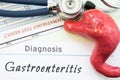 Model of stomach, blood test and stethoscope lying next to written title on paper diagnosis Gastroenteritis. Concept photo of caus