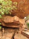 A model of Stone Age family as well as actual petroglyphs on cave ceiling, Bhimbetka rock shelter, Madhya Pradesh, India Royalty Free Stock Photo