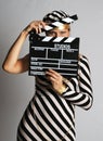 Model in stripy dress and cap at shooting