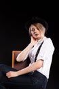 Model with suspenders and white shirt wearing a hat Royalty Free Stock Photo