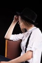 Model with suspenders and white shirt wearing a hat Royalty Free Stock Photo