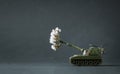 Model toy of battle tank firing flowers from the barrel. Peace and no war concept. Royalty Free Stock Photo