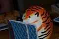 A model or toy of a hedgehog with tiger stripes playing cards Royalty Free Stock Photo