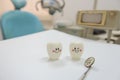 Model toys teeth and equipment in Dental room background.