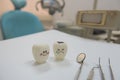 Model toys teeth and equipment in Dental room background.