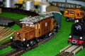 Historic electric locomotive with freight wagon on the model railway