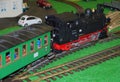 Model train with steam locomotive and old passenger car