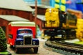 Model Truck and Locomotive on track with vintage box truck in forefront. Royalty Free Stock Photo