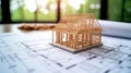 Under construction wooden frame house model on blueprints with copy space Royalty Free Stock Photo