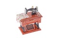 Model of vintage sewing machine on white background.