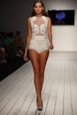 A model walks runway in designer swim apparel during the Furne Amato fashion show