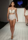 A model walks runway in designer swim apparel during the Furne Amato fashion show