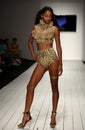 A model walks runway in designer swim apparel during the Furne Amato fashion show