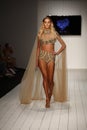 A model walks runway in designer swim apparel during the Furne Amato fashion show