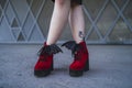 Model wearing the beautiful blood-red high heels with bat wings