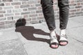 Model wearing black and white sandals with zebra print.