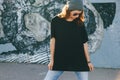 Model wearing plain tshirt and sunglasses posing over street wall Royalty Free Stock Photo