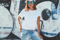 Model wearing plain tshirt and sunglasses posing over street wall Royalty Free Stock Photo