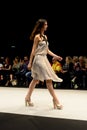 Model wearing a silver white dress on the catwalk during the Adlib fashion collection at Momad 2023