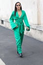 Model wears an emerald green dress and a pair of sunglasses during the Prada show for the spring / summer 2020 collection