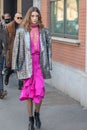 Model wears a fuchsia dress, a silver jacket and python socks