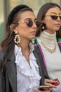 Model wears pearl earrings and a pair of original sunglasses