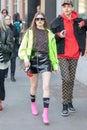 Model wears a shiny black miniskirt and a Fendi shirt