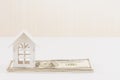 Model white house on hundred dollars banknote. Property investment and house mortgage financial concept, Royalty Free Stock Photo