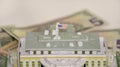 Model of the White House of the President on the background of dollars