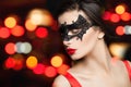 Model woman in fashion carnival mask on abstract nightly glitter bokeh background Royalty Free Stock Photo